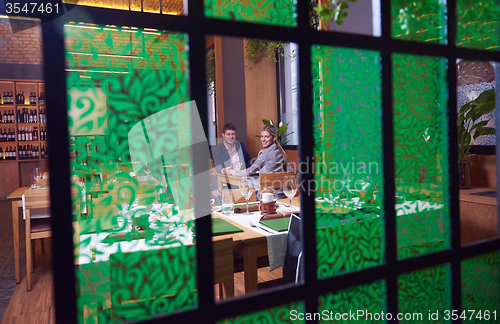 Image of business couple having dinner