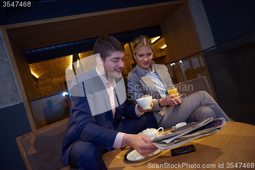 Image of business couple take drink after work