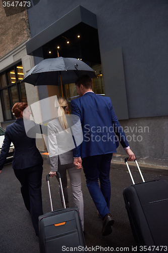 Image of business people couple entering  hotel