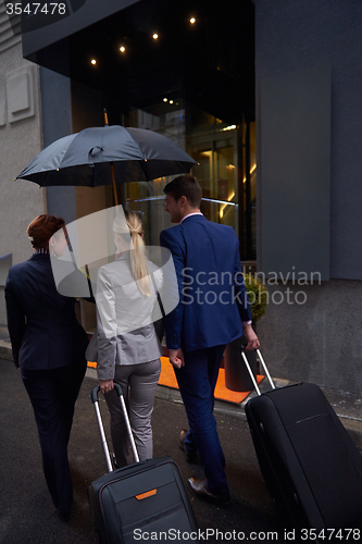 Image of business people couple entering  hotel