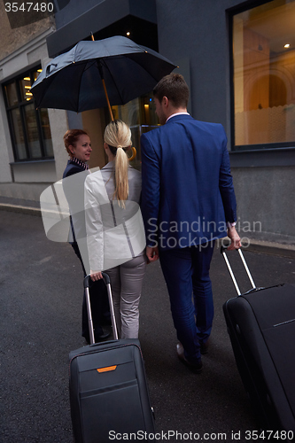 Image of business people couple entering  hotel