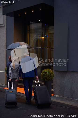 Image of business people couple entering  hotel