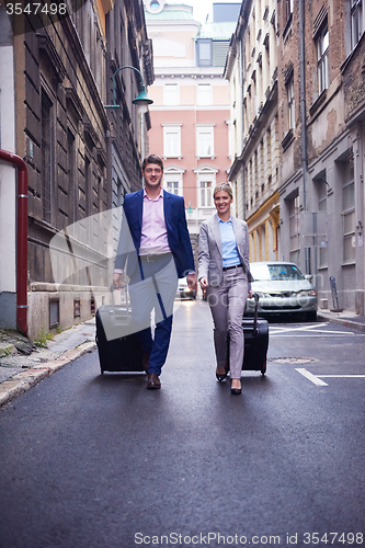 Image of business people couple entering  hotel