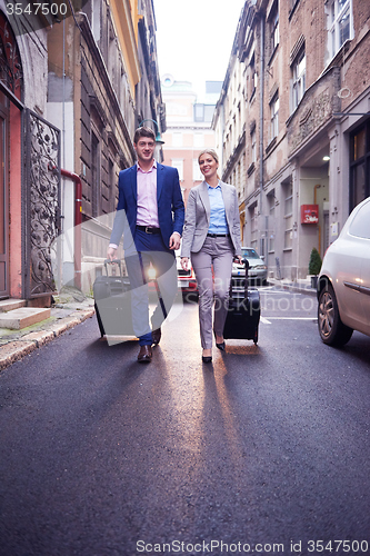 Image of business people couple entering  hotel