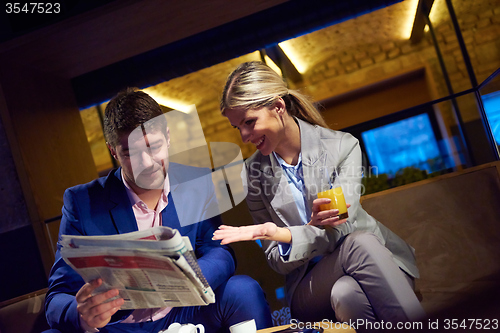 Image of business couple take drink after work