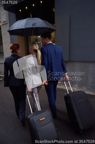 Image of business people couple entering  hotel