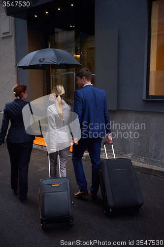 Image of business people couple entering  hotel