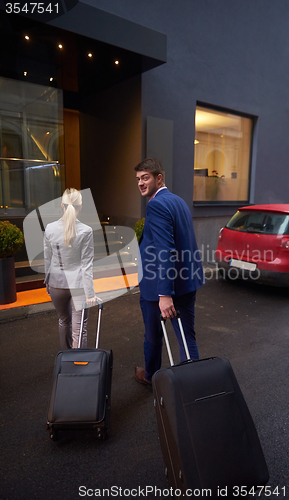 Image of business people couple entering  hotel