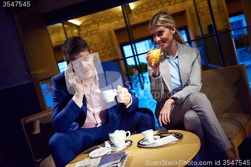 Image of business couple take drink after work