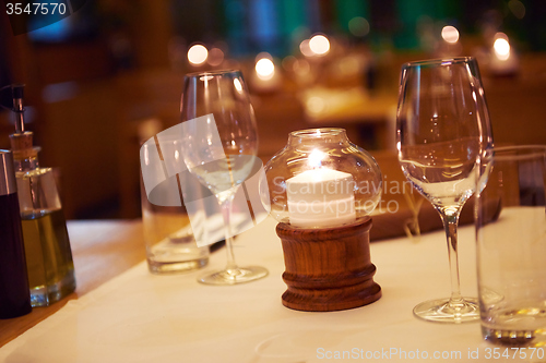 Image of Wine bottles on a wooden shelf.