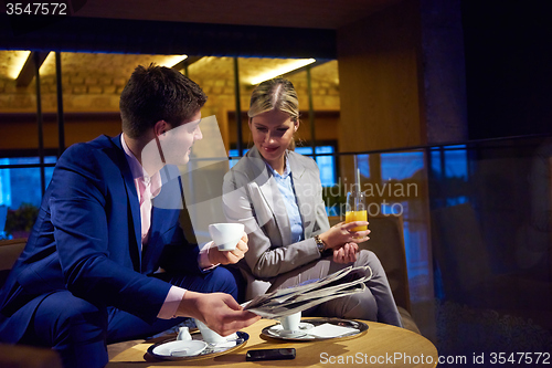 Image of business couple take drink after work