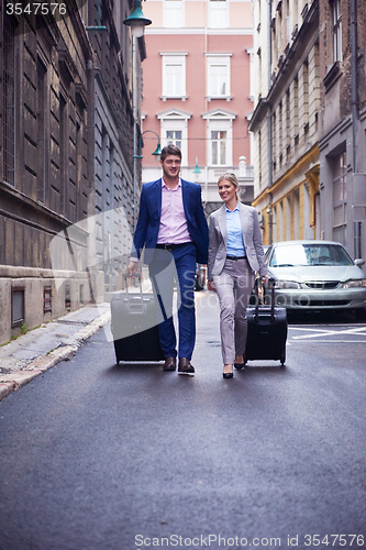 Image of business people couple entering  hotel