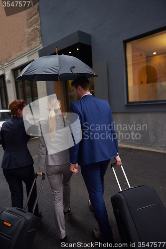 Image of business people couple entering  hotel