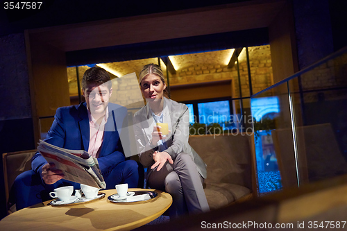 Image of business couple take drink after work