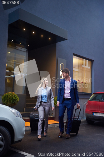 Image of business people couple entering  hotel