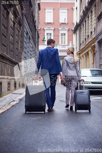 Image of business people couple entering  hotel