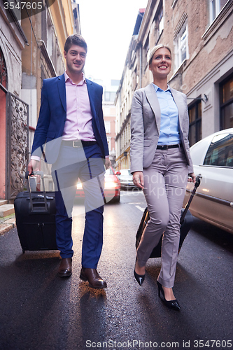 Image of business people couple entering  hotel