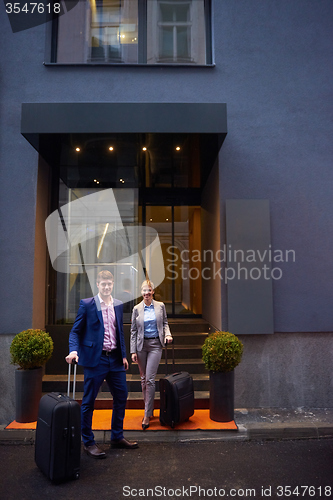 Image of business people couple entering  hotel