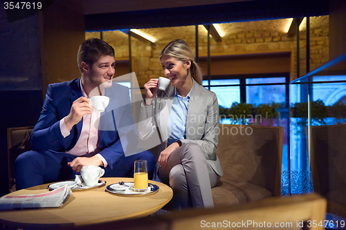 Image of business couple take drink after work