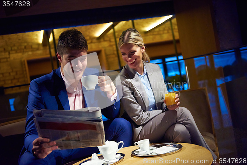 Image of business couple take drink after work