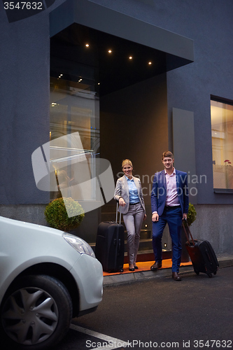 Image of business people couple entering  hotel