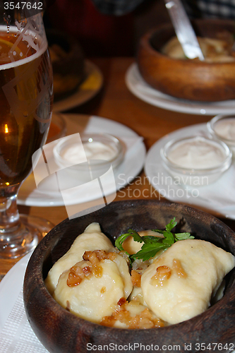 Image of dumplings with bacon and sour cream in the restaurant