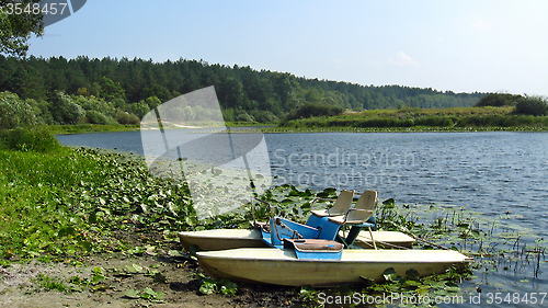 Image of landscape with catamarans on the river