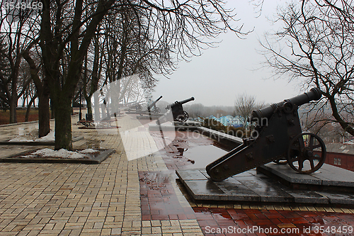 Image of old cannons in the park in gloomy February