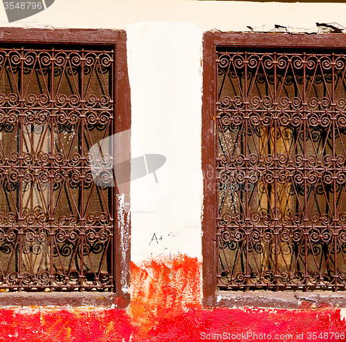 Image of red   window in morocco africa old construction and brown wall  