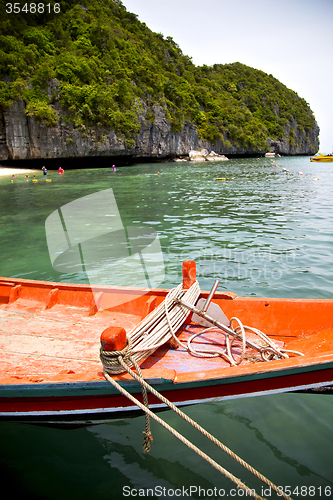 Image of  boat coastline of a  green lagoon and tree  people