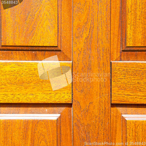 Image of abstract texture of a brown antique wooden old door in italy   e