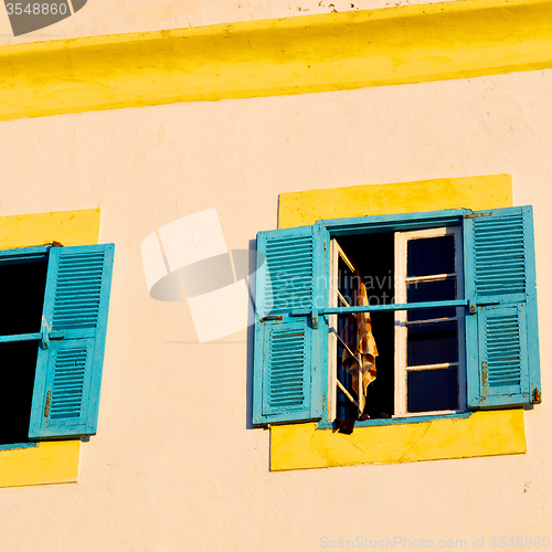 Image of blue window in morocco africa old construction and brown wall  c