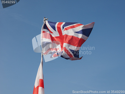 Image of Flag of UK over blue sky