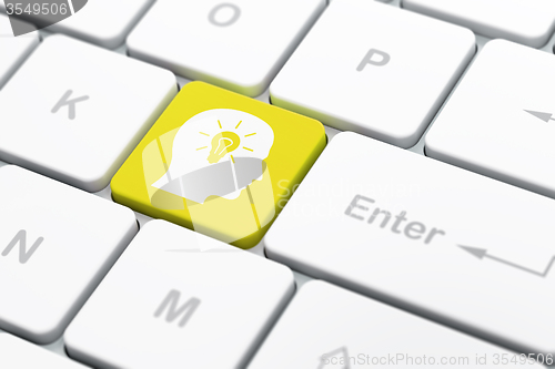 Image of Business concept: Head With Light Bulb on computer keyboard background