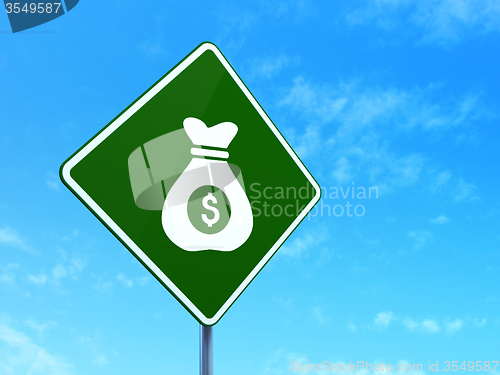 Image of Business concept: Money Bag on road sign background