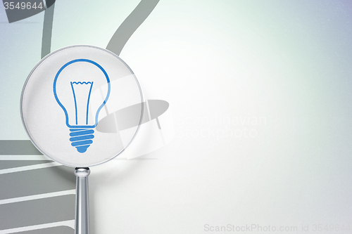 Image of Business concept:  Light Bulb with optical glass on digital background