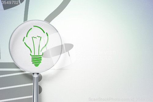 Image of Finance concept:  Light Bulb with optical glass on digital background