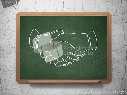 Image of Business concept: Handshake on chalkboard background