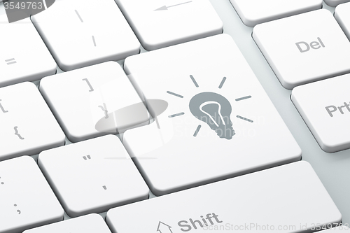 Image of Finance concept: Light Bulb on computer keyboard background