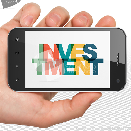 Image of Finance concept: Hand Holding Smartphone with Investment on  display