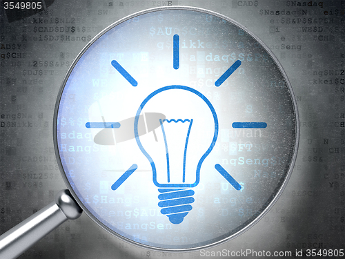 Image of Finance concept: Light Bulb with optical glass on digital background