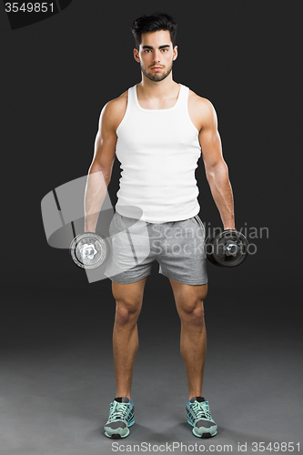 Image of Athletic man lifting weights