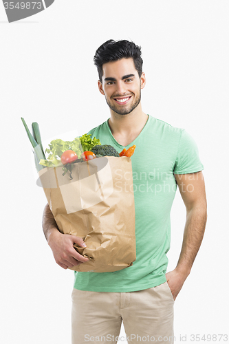 Image of Man carrying a bag full of vegetables