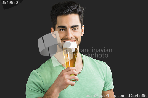 Image of Young man drinking beer