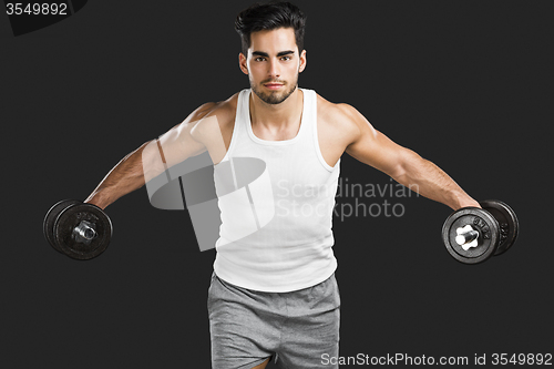 Image of Athletic man lifting weights