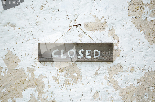 Image of Closed at an old wooden sign
