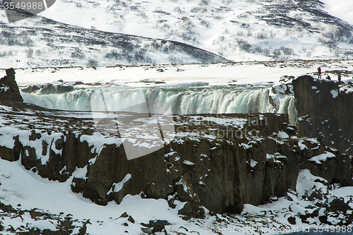 Image of Tourists at the Icelandic waterfall Godafoss in wintertime