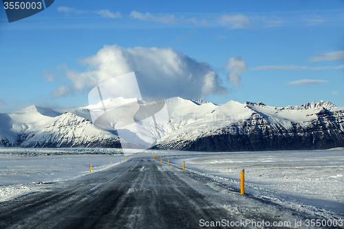 Image of Snowy road with volcanic mountains in wintertime