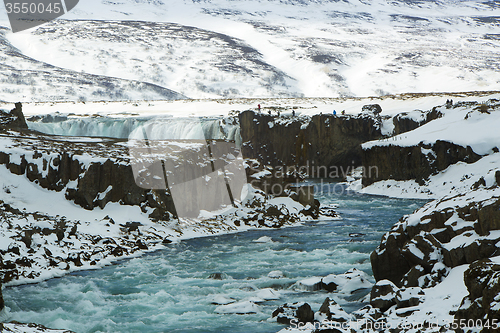 Image of Tourists at the Icelandic waterfall Godafoss in wintertime