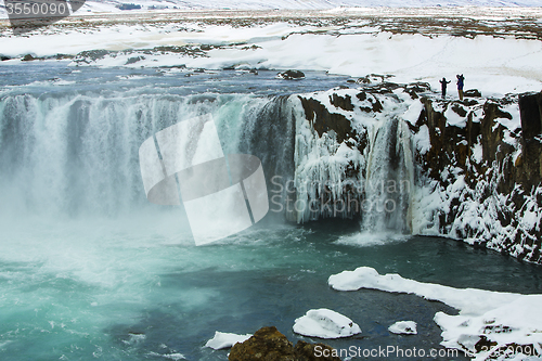 Image of Tourists at the Icelandic waterfall Godafoss in wintertime
